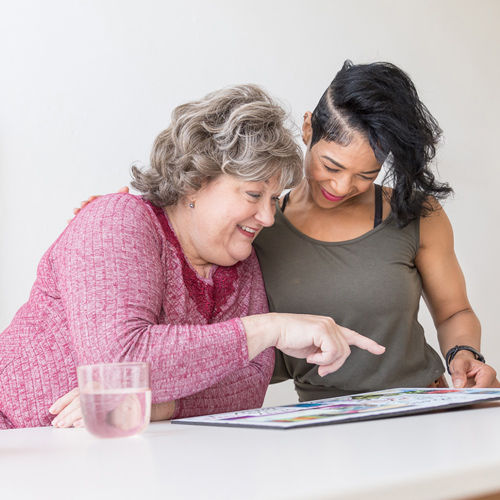 two health and wellness coaches reviewing materials